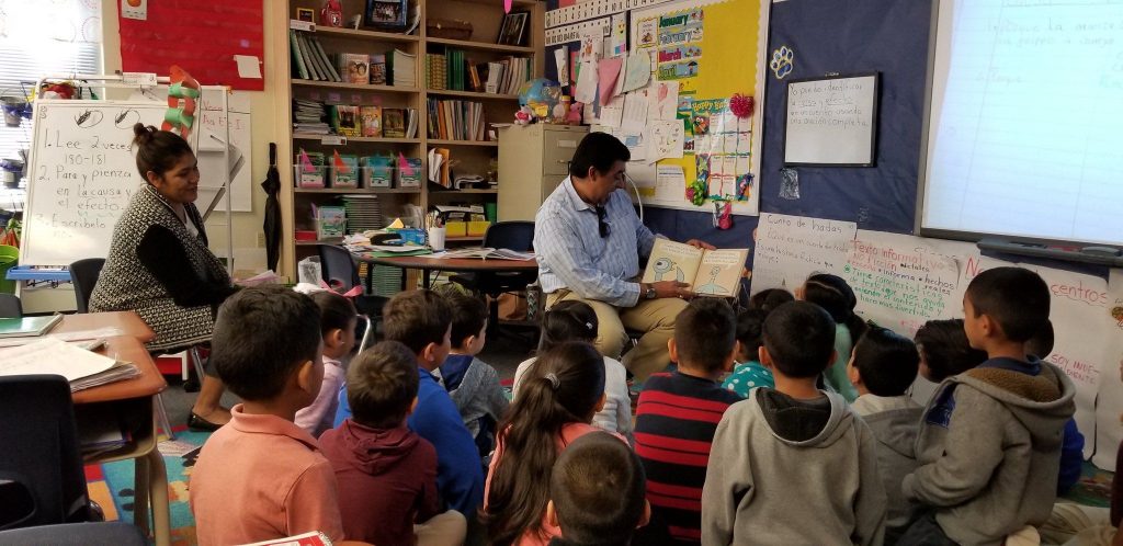 Aaron Martinez reading to children at Orr Elementary